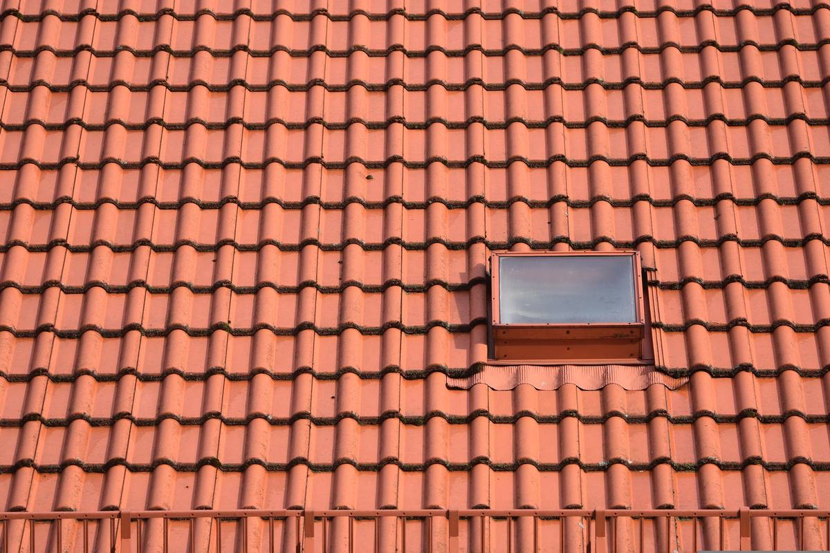 Neatly laid pitched tile roof with a skylight